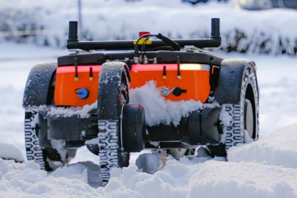 the Capra robot driving in the snow while signaling to the right