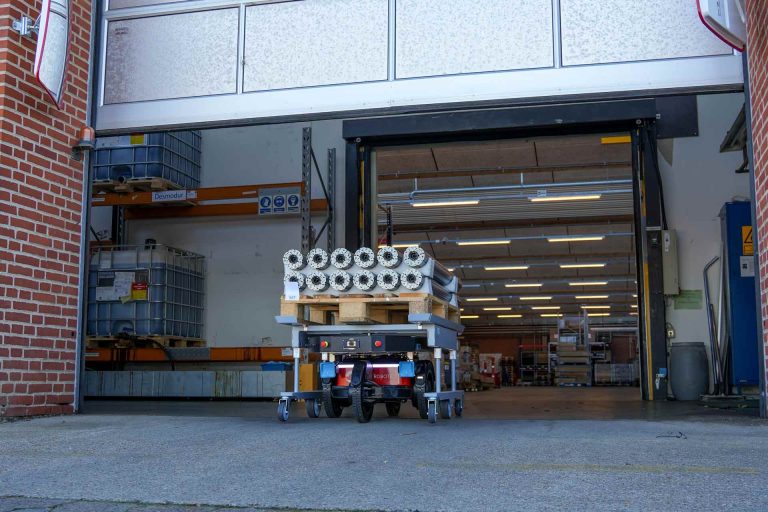 logistics robot with cart driving out of the gate